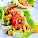 Bite size lettuce wraps with mango chile shrimp and mango salsa
