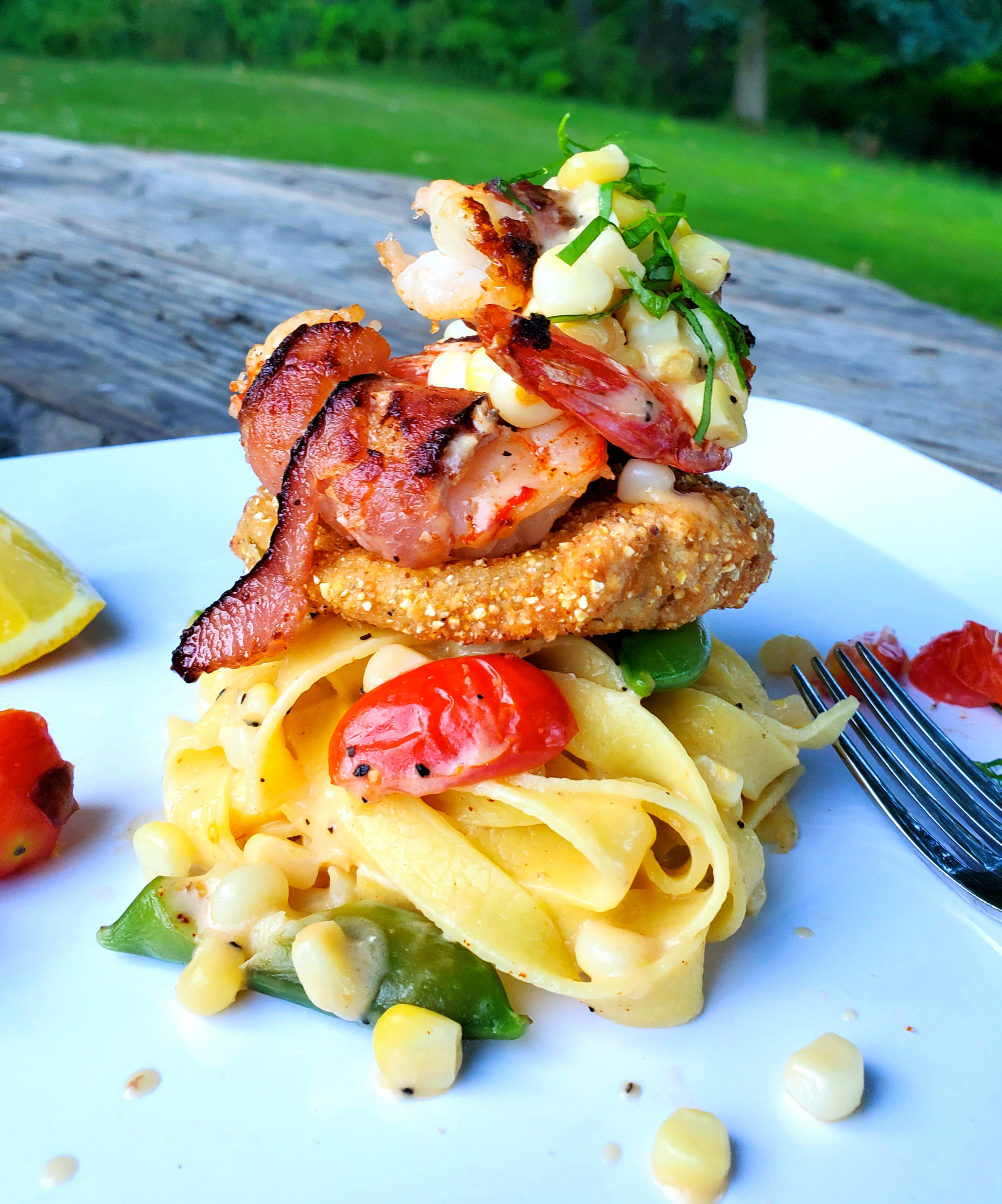 Cajun Carbonara piled high with fried green tomato and bacon wrapped shrimp