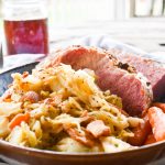 Tender, flavorful oven roasted corned beef with quick cabbage cooked in bacon fat