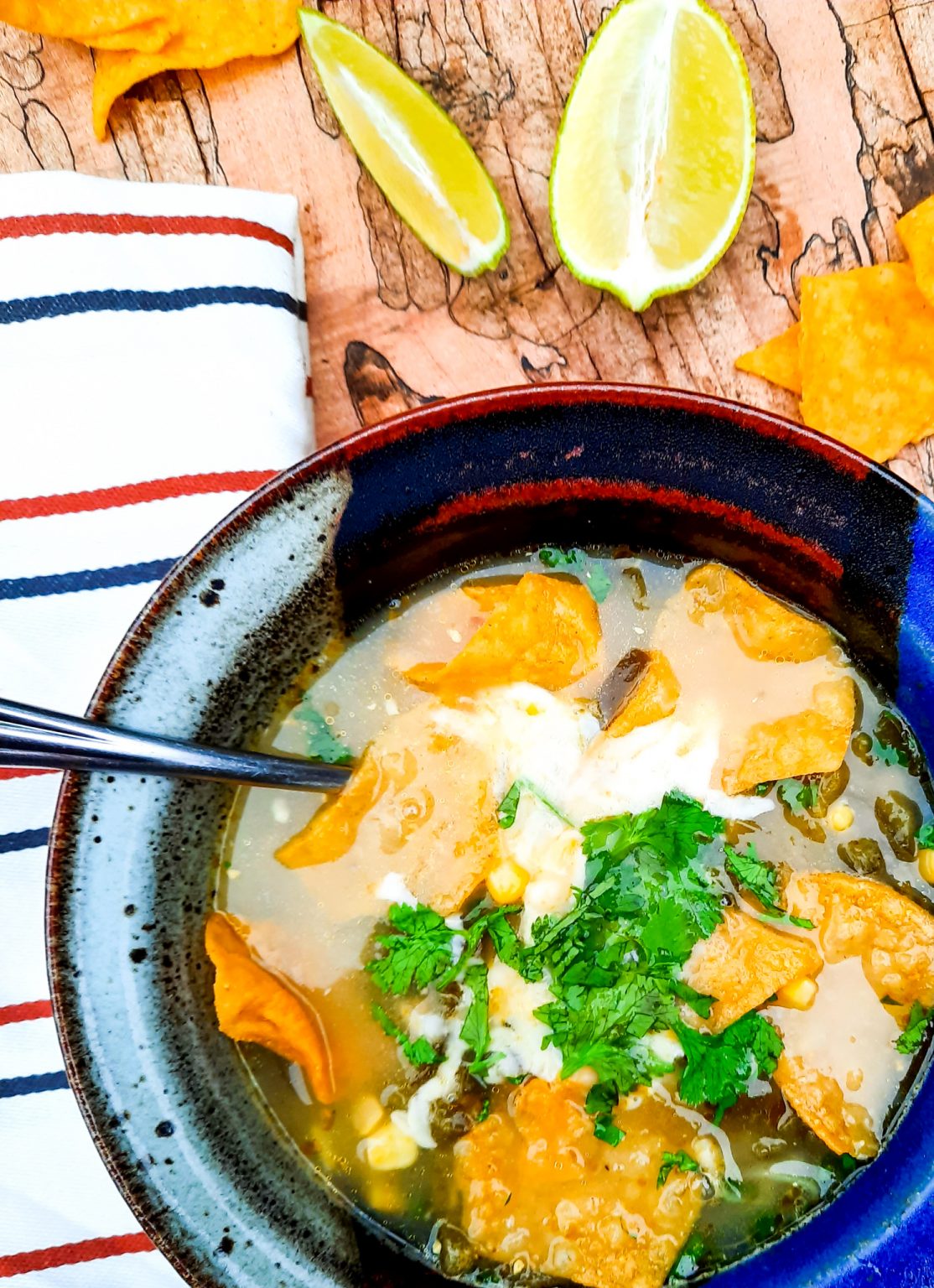 Flavorful broth based Poblano Corn Tortilla Soup with cilantro, lime and Queso Oaxaca