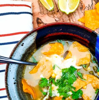 Flavorful broth based Poblano Corn Tortilla Soup with cilantro, lime and Queso Oaxaca