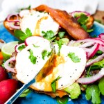 Avocado Breakfast Molette is a Mexican inspired avocado toast with layers of pinto beans, smashed avocado, pickled onions, Cotija cheese, cilantro and a fried egg on a bolillo roll.