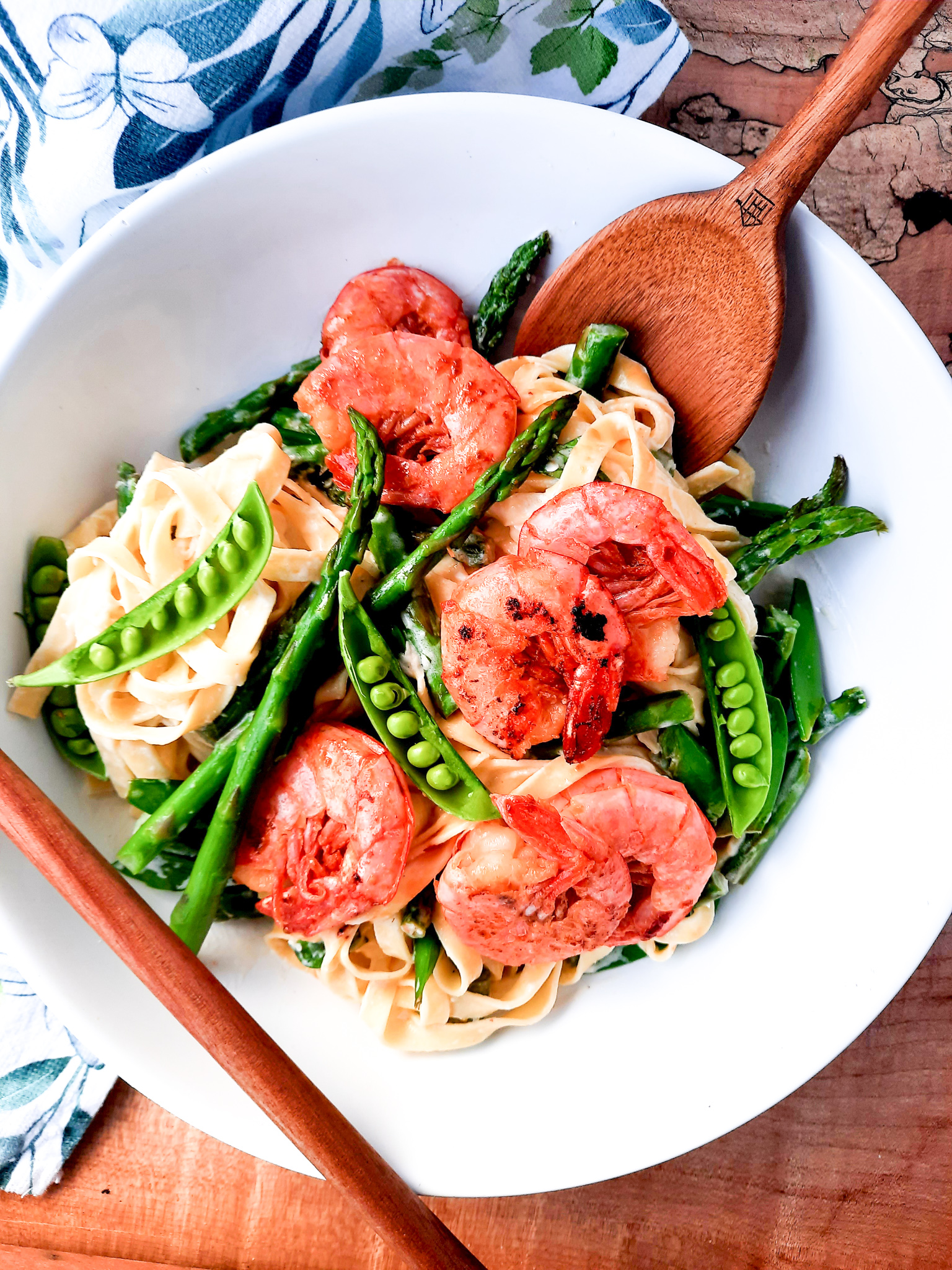 Creamy Spring Pasta with Shrimp combines first of the season asparagus and peas in a cream based sauce with tender garlic shrimp.