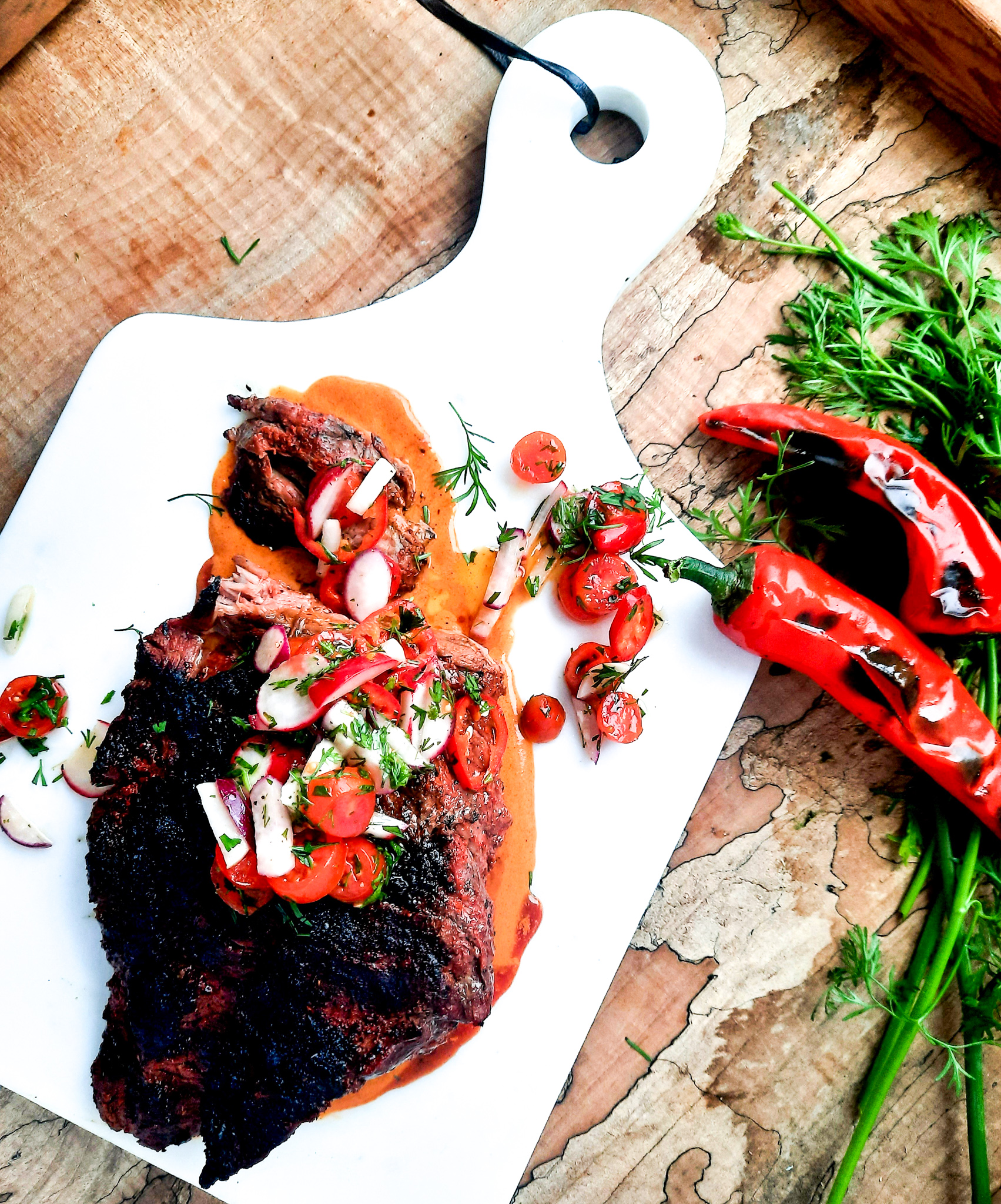 Grilled Bavette Steak with Smoked Paprika Sauce has a spicy seasoned crust and a juicy tender inside with fresh tomato radish salad.