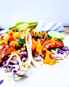 Nearly guilt free, these Grilled Pacific Rock Fish Tacos skip the typical dredging and go straight for the grill. Topped with fresh mango salsa and served in a warm flour tortilla with chipotle slaw.