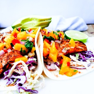Nearly guilt free, these Grilled Pacific Rock Fish Tacos skip the typical dredging and go straight for the grill. Topped with fresh mango salsa and served in a warm flour tortilla with chipotle slaw.