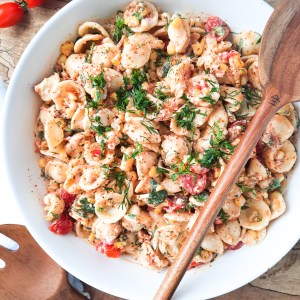 Mexican Street Corn Pasta Salad with fresh corn, tomatoes, chilies, bacon, cilantro, cotija cheese and orecchiette pasta in a creamy Tajin dressing.