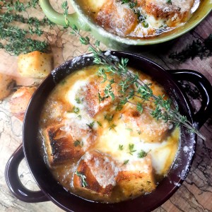 Bistro French Onion Soup with rich, flavorful beef broth and slowly caramelized onions topped with French bread croutons and gruyere cheese.
