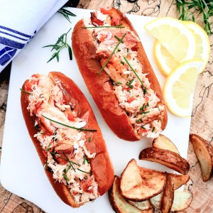 Dungeness Crab Rolls let the crab shine with butter warmed lump pieces, minced red pepper, tarragon, smoky chipotle and a squeeze of lemon.