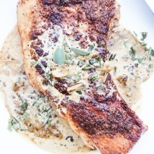 Pan Seared Pork Chops with Sage Cream Sauce utilizes a cast iron pan to created a juicy chop with a seasoned crust and a delicious pan sauce.
