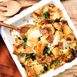 Sourdough Stuffing with Roasted Garlic is the most flavorful addition to your holiday table with bacon, greens and Swiss cheese.