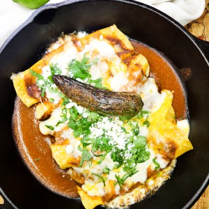 Chorizo and Jack Enmoladas are flavorful enchiladas coated in earthy mole sauce topped with Monterrey Jack cheese and baked until bubbly.