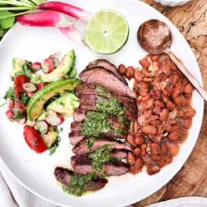 Cilantro Chimichurri Flank Steak is seasoned, quickly grilled and served sliced with fresh cilantro chimichurri sauce and sides.