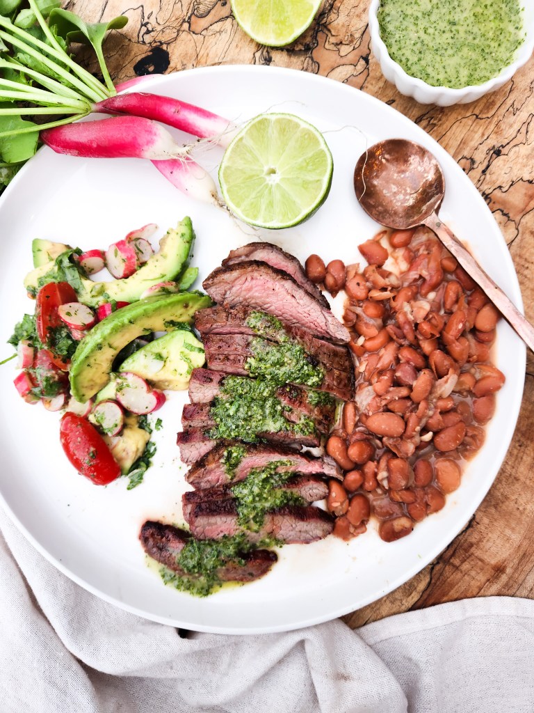 Cilantro Chimichurri Flank Steak is seasoned, quickly grilled and served sliced with fresh cilantro chimichurri sauce and sides. 