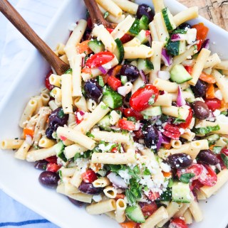 Greek Pasta Salad made with penne rigate and plenty of vinaigrette with cucumber, kalamata olives, bell pepper, grape tomatoes and feta.