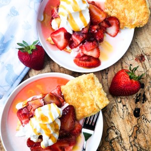 Hot Honey Strawberry Shortcake layers fresh sliced strawberries with cornmeal biscuits, whipped cream and a hot honey drizzle.