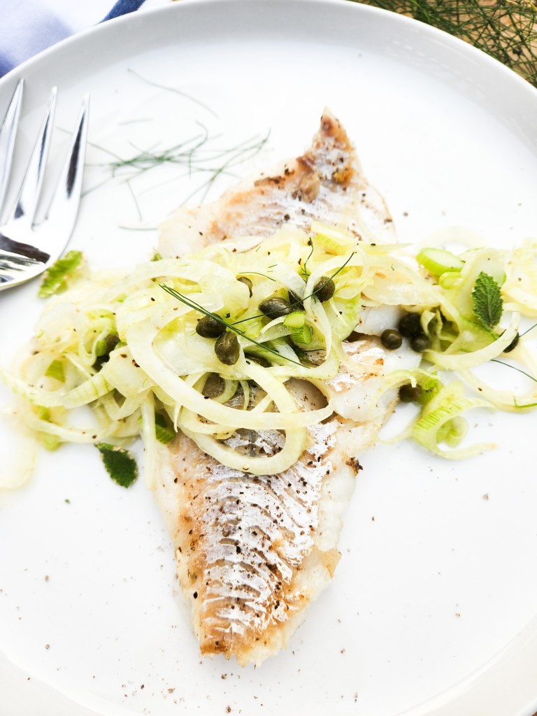 Seared Cod with Fennel Slaw highlights the simplicity of flaky cod with earthy fennel bulb, briny capers and accents of citrus.