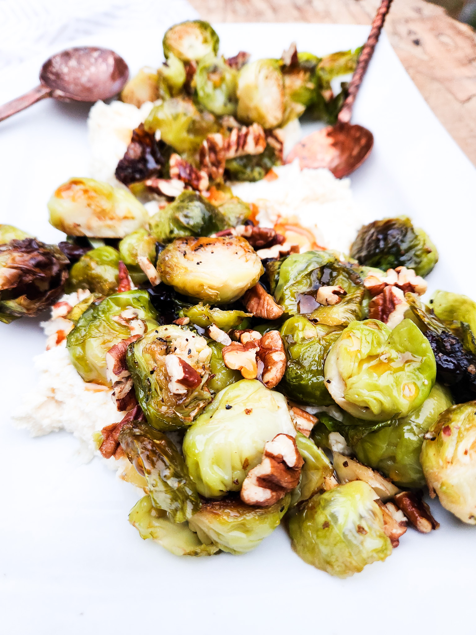 Roasted Brussels Sprouts with honey whipped goat cheese, toasted pecans, dried tart cherries and hot honey drizzle.