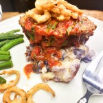 Nona's Glazed Meatloaf is packed with flavor and moisture from finely chopped carrot, celery and onion topped with a sweet and tangy glaze.