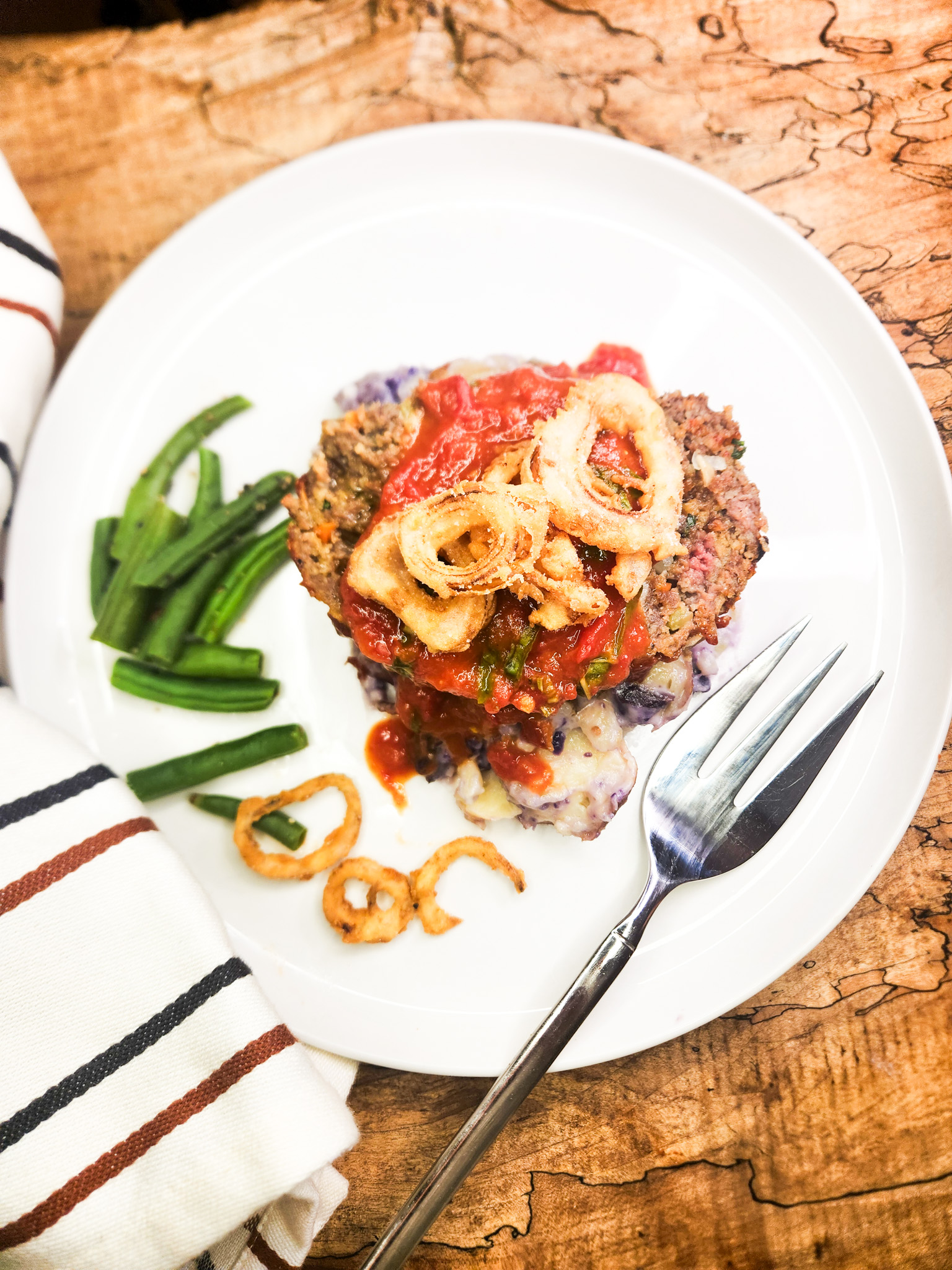 Nona's Glazed Meatloaf is packed with flavor and moisture from finely chopped carrot, celery and onion topped with a sweet and tangy glaze.