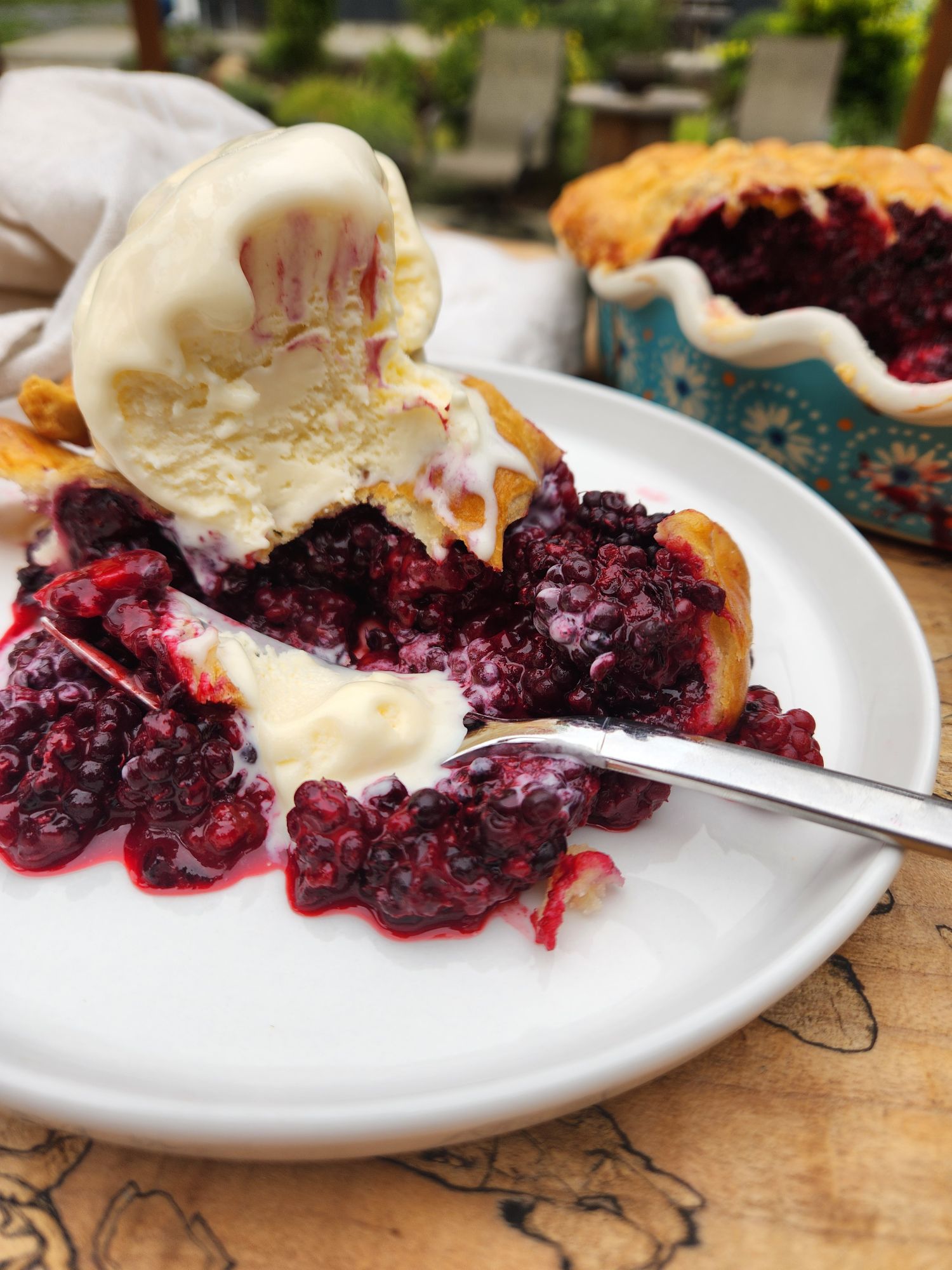 Wild Blackberry Pie with a light and flaky all butter crust, fresh picked blackberries served warm with vanilla ice cream.