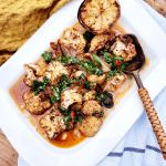 Moroccan Roasted Cauliflower over creamy white bean puree with chili herb gremolata and charred lemon.