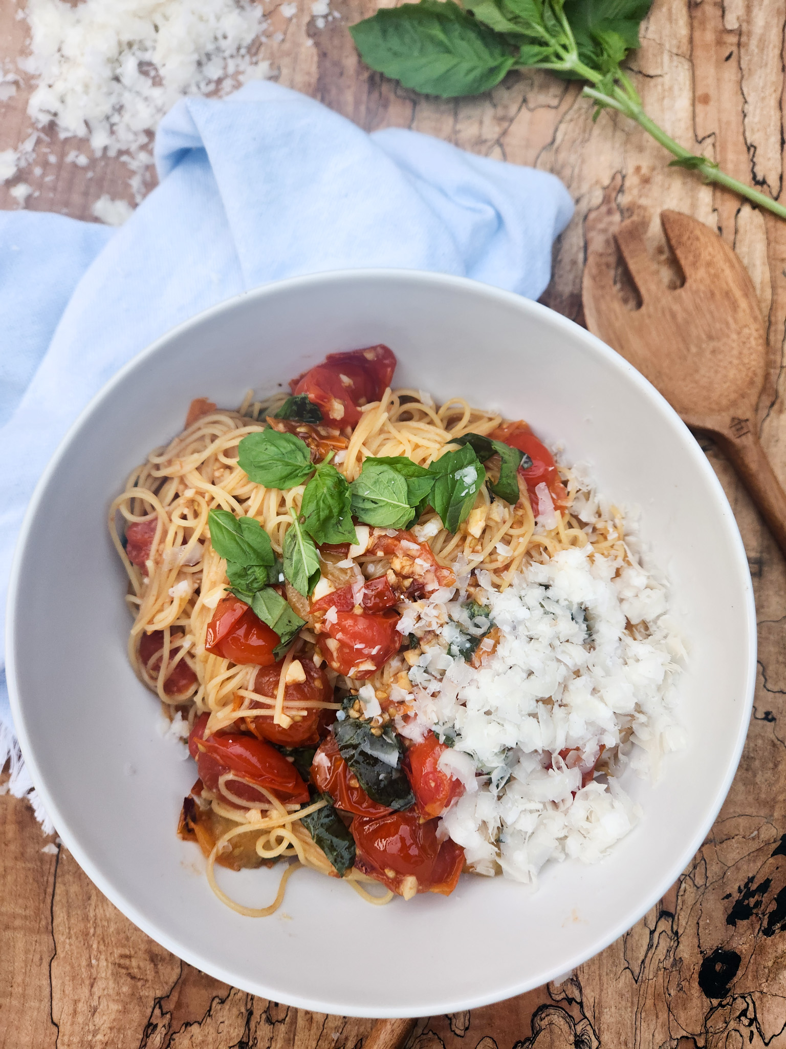 Blistered Tomato Basil Pasta with vine ripened cherry tomatoes, fresh basil and garlic in an olive oil sauce over angel hair pasta.