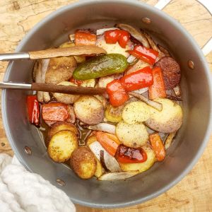 Country Style Potatoes are thick sliced yellow potatoes fried in bacon fat for an extra crispy crust with red pepper, jalapeno and onion.