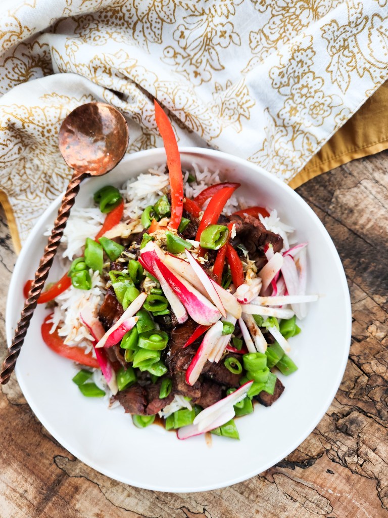 Thai Grilled Beef Bowls combines grilled steak marinated in Pad Thai sauce with cabbage, red pepper, sugar snap peas and radish.