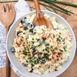 Chrissey Lou's Pasta Salad is a classic macaroni salad with creamy dressing, eggs, olives, celery, red onion and chives.