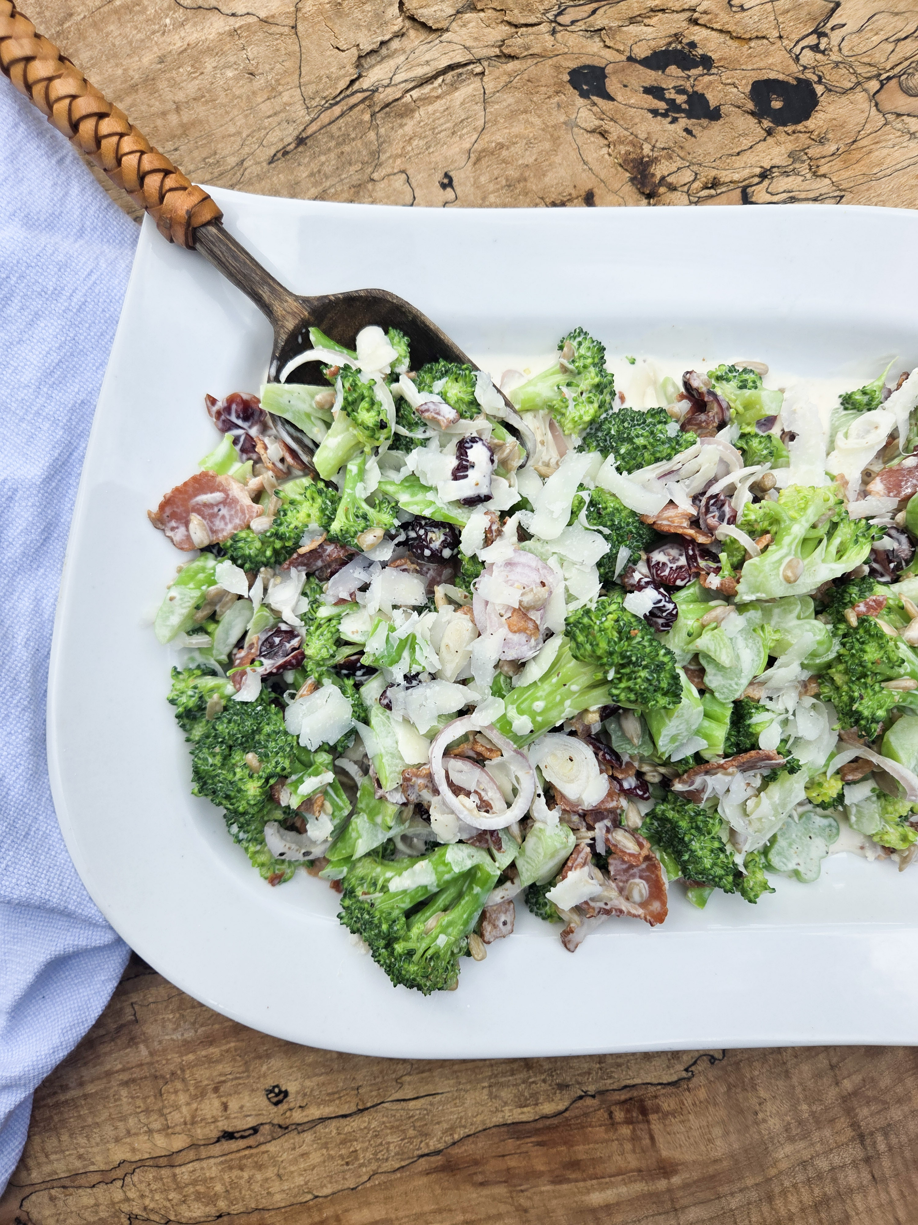 Modern Broccoli Salad is an updated version of the classic with shallots, bacon, cranberries, sunflower seeds and Pecorino cheese.