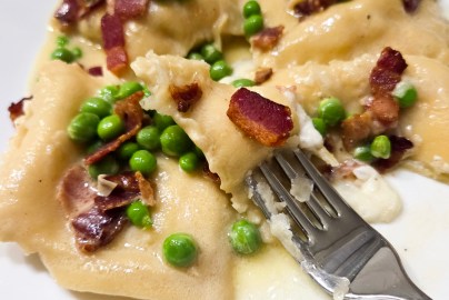 Lemon Ricotta Ravioli with Bacon and Peas is made from scratch coated in a white wine, garlic butter sauce.