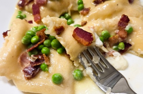 Lemon Ricotta Ravioli with Bacon and Peas is made from scratch coated in a white wine, garlic butter sauce.
