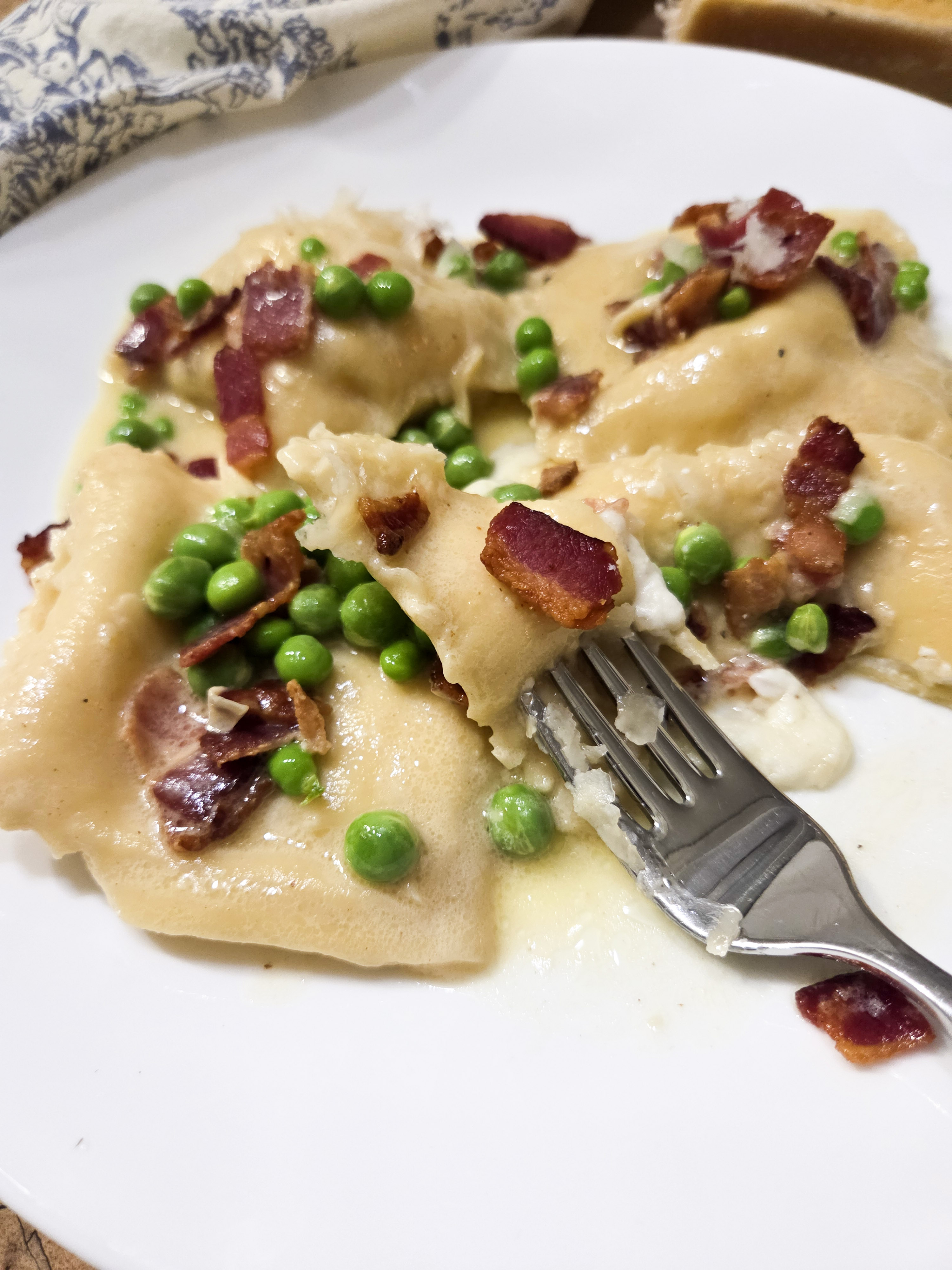 Lemon Ricotta Ravioli with Bacon and Peas is made from scratch coated in a white wine, garlic butter sauce.